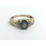 A 9ct yellow gold ring set with central blue stone