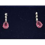 A pair of 18ct white gold ruby and diamond drop ea