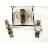 Three wrist watches with boxes including a Guess