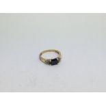 An 18ct gold ring set with 6 diamonds and 1 sapphi