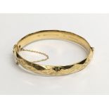 A 9ct gold metal cored bangle