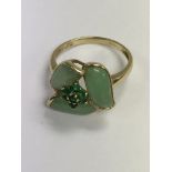 A 9 ct gold ring inset with green stone of floral