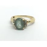 An 18ct yellow gold ring set with a green stone an