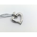 An 18ct white gold heart shaped pendant with singl