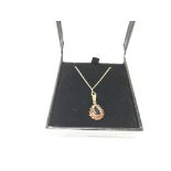 A 9ct gold and garnet set pendant and chain.