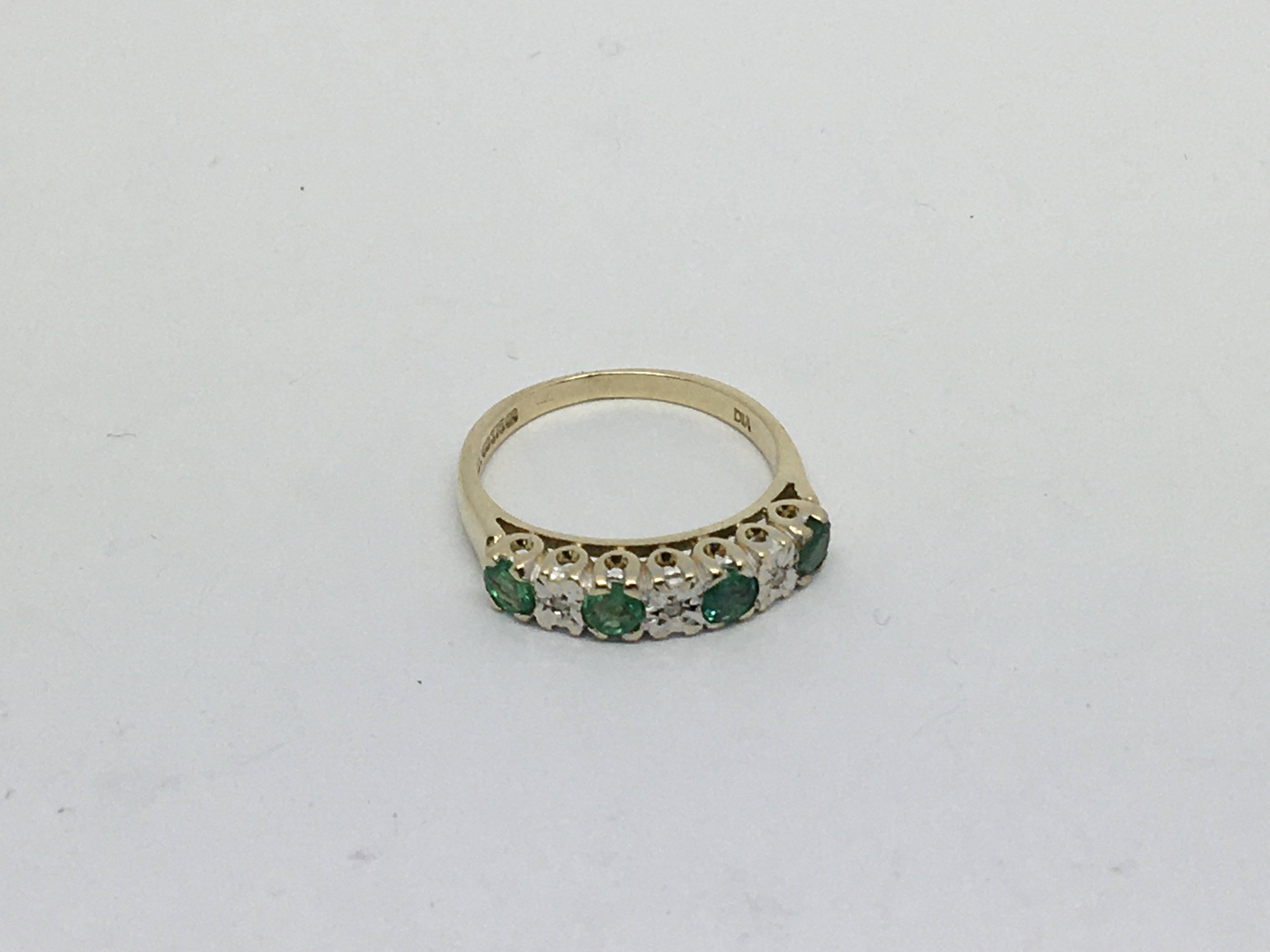 A 9ct gold ring set with 4 emeralds and 4 diamonds