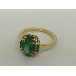 A yellow gold emerald and diamond ring, emerald 1.