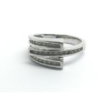 A 9ct white gold ring set with three rows of diamo