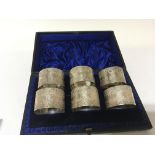 A numbered set of six silver napkin rings with flo