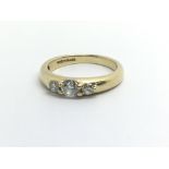 An 18ct yellow gold and three stone diamond ring,