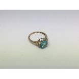 A 9ct gold ring set with 1 topaz and 2 diamonds. S