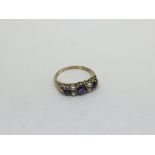 A 9ct gold ring set with 3 amethysts and pearls. S