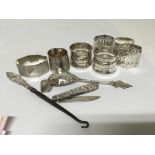 A collection of silver napkin rings a button hook