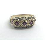 A 9ct yellow gold ring set with rubies and diamond