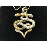A silver and silver gilt entwined snake pendant wi
