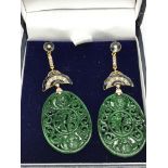 A pair of oval shaped patterned jade drop earrings