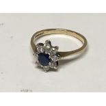 A 9carat gold ring set with a sapphire and small b