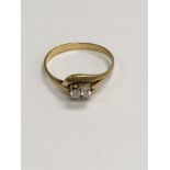 A 18 ct gold ring inset with two small diamonds. S