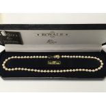 A Royal Lotus simulated pearl necklace having silv