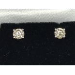 A pair of 18ct white gold 4-claw RBC diamond studs