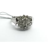 An 18ct white gold and diamond cluster ring, appro