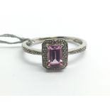 A 9ct white gold ring set with pink sapphire and s