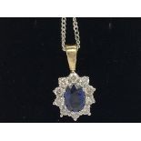 An 18ct yellow and white gold oval-cut sapphire an