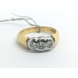 An 18ct yellow gold ring set with three diamonds,