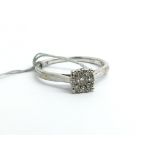 A 9ct white gold ring set with a cluster of nine d