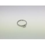 A 9ct white gold 0.30 ct solitaire diamond ring. S