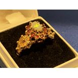 A 9ct gold opal and garnet ring, 3.3g.