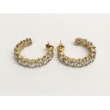 A pair of 9ctt gold and CZ hoop style earrings