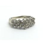 A 14ct white gold and diamond cluster ring set wit