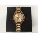 A boxed Michael Kors rose gold wristwatch