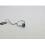 A 9ct white gold ring set with a blue stone and di
