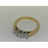 An 18ct yellow gold princess cut 3 stone diamond r