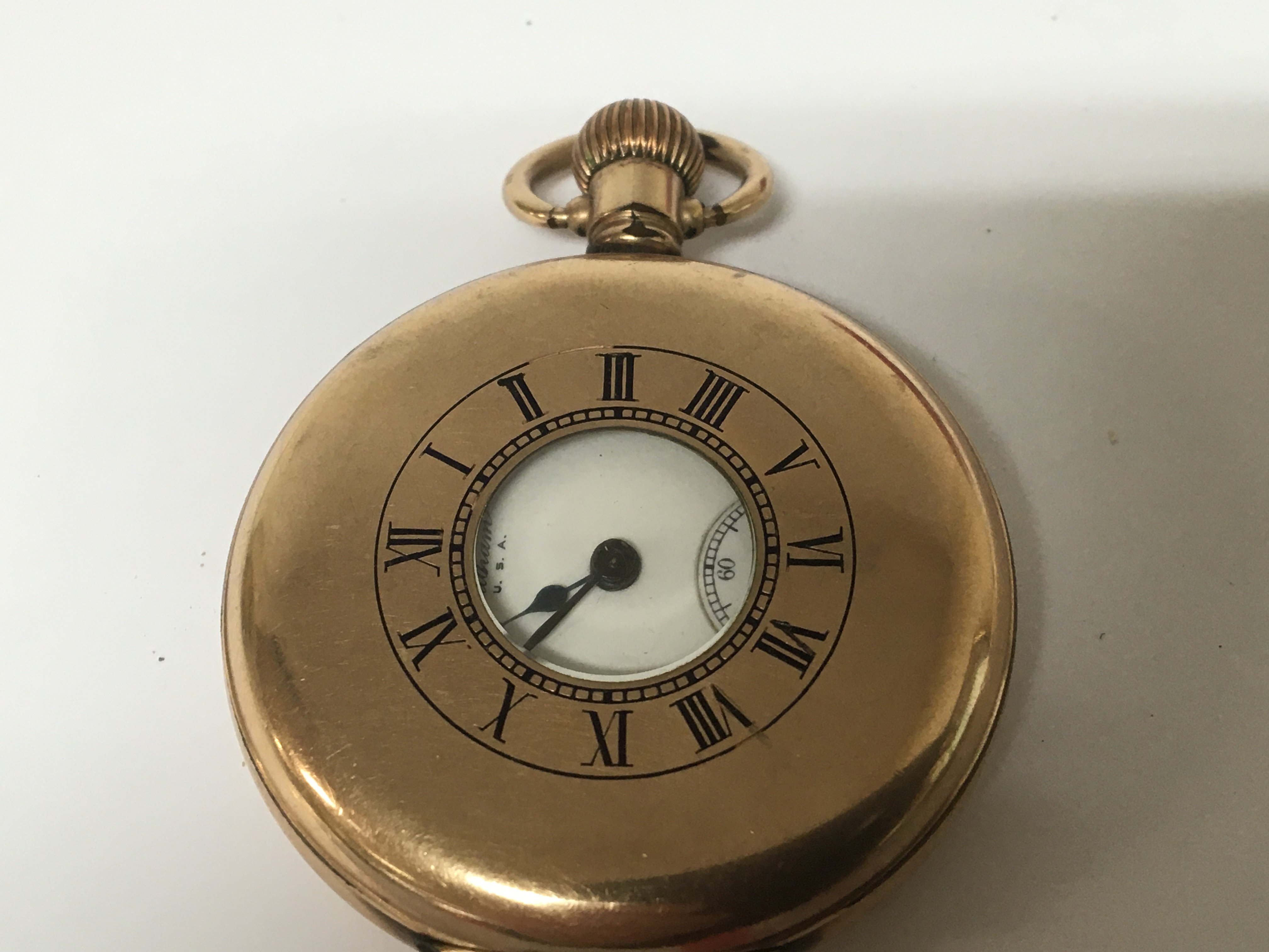 A gold plated half hunter button wind pocket watch