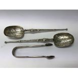 A pair of ornate hallmarked silver anointing spoon