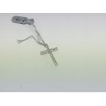 An 18ct white gold diamond cross pendant. Approx w