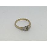 A 9ct gold ring set with 3 small diamonds. Size m/