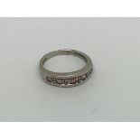A 9ct white gold ring set with pink sapphires and