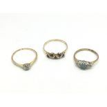 Three gold rings, set with various stones includin