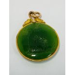 An unmarked gold mounted nephrite jade pendant wit