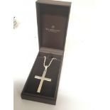 A large silver cross pendent on a closed bead silv