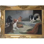 A framed oil painting on canvas depicting a group of dogs. Indistinctly signed and in a gilt