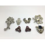 A small collection of silver brooches and earrings