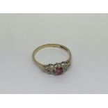 A 9ct gold ring set with a pink sapphire and 6 dia