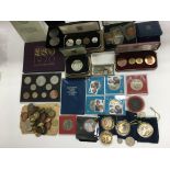 A collection of various coins, some cased and some