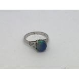 A 14ct white gold ring set with a black opal. Size