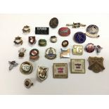 A collection of metal and enamel badges, various c